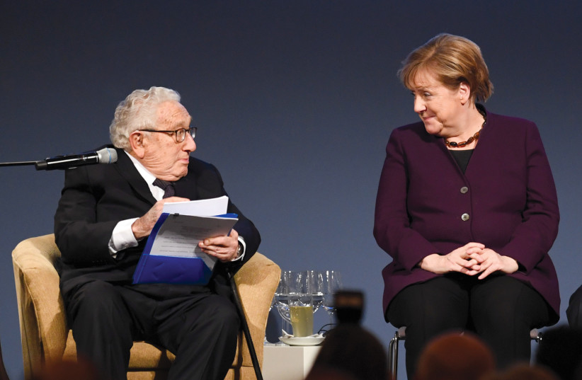  Former German chancellor Angela Merkel chats with former US secretary of state Henry Kissinger at the American Academy’s award ceremony at Charlottenburg Palace in Berlin in 2020.  (photo credit: ANNEGET HILSE/REUTERS)