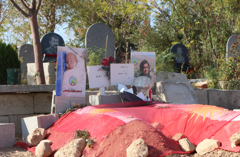  GRAVES OF Reyhana Rahmani and baby son Waniar, killed in Iranian strike on PDKI headquarters.  (credit: JONATHAN SPYER)