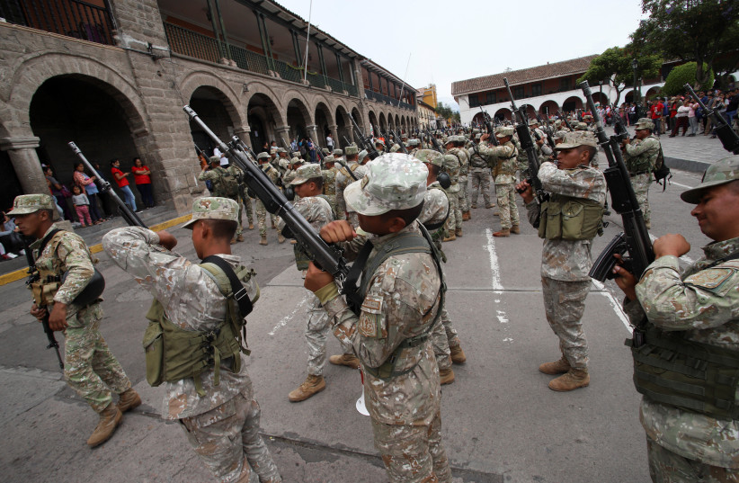  Soldiers take their weapons after they arrived as reinforcements amid violent protests following the ousting and arrest of former President Pedro Castillo, in Ayacucho, Peru December 15, 2022. (photo credit: REUTERS/Miguel Gutierrez Chero)