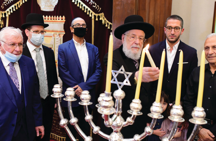  RABBI YISRAEL Meir Lau lights the hanukkiah at the Tel Aviv Great Synagogue on the fourth night of Hanukkah, last year. (photo credit: TOMER NEUBERG/FLASH90)