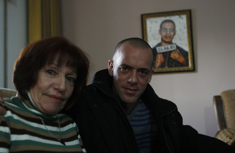  Salah Hamouri poses for a photograph with his mother during an interview with Reuters in the West Bank neighbourhood of Dahiyet al-Barid, on the outskirts of Jerusalem December 19, 2011. (credit: MOHAMAD TOROKMAN/REUTERS)