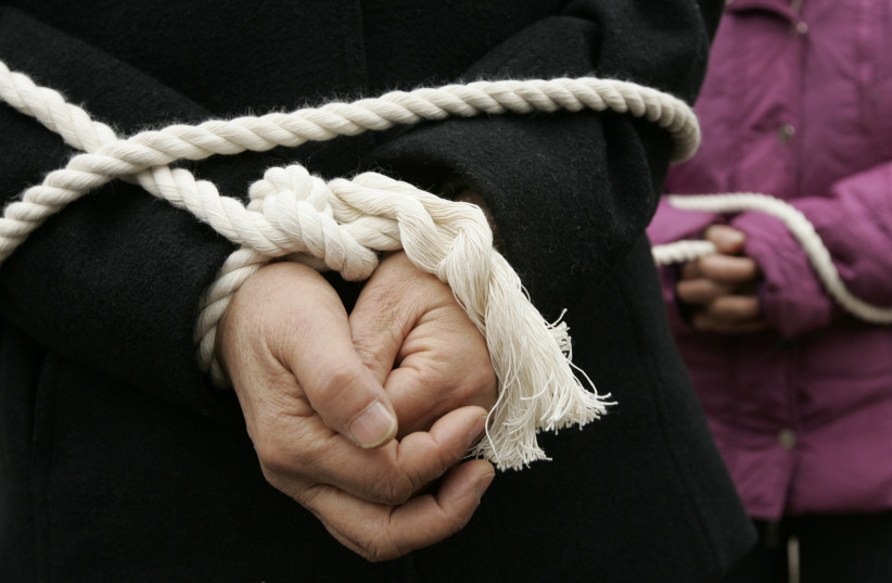  Hands tied with rope (illustrative). (photo credit: Lee Jae-Won/REUTERS)