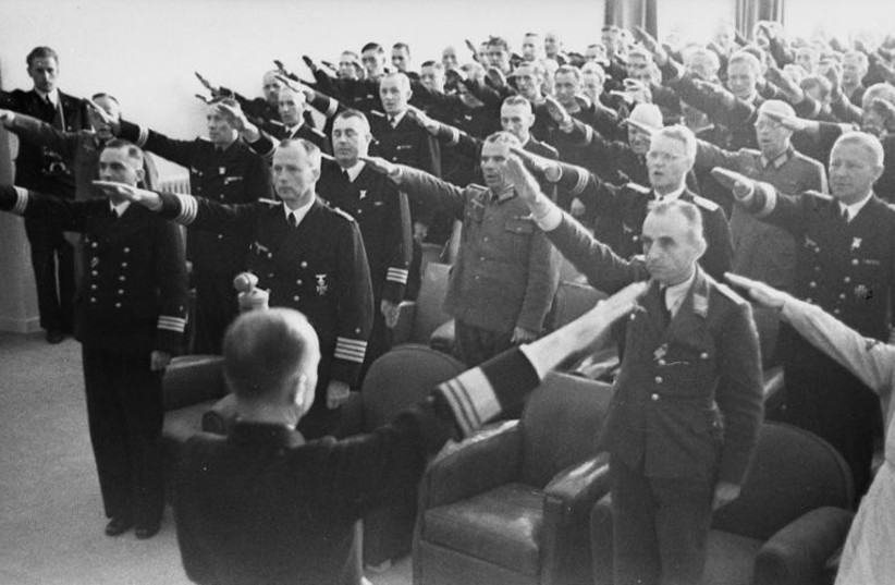  Karl Dönitz in front of assembled officers performing the Nazi salute (credit: Wikimedia Commons)