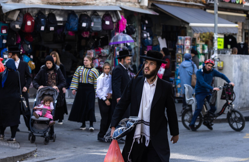  People walk in Mea Shearim neighborhood on November 22, 2022 in Jerusalem. (credit: OLIVIER FITOUSSI/FLASH90)