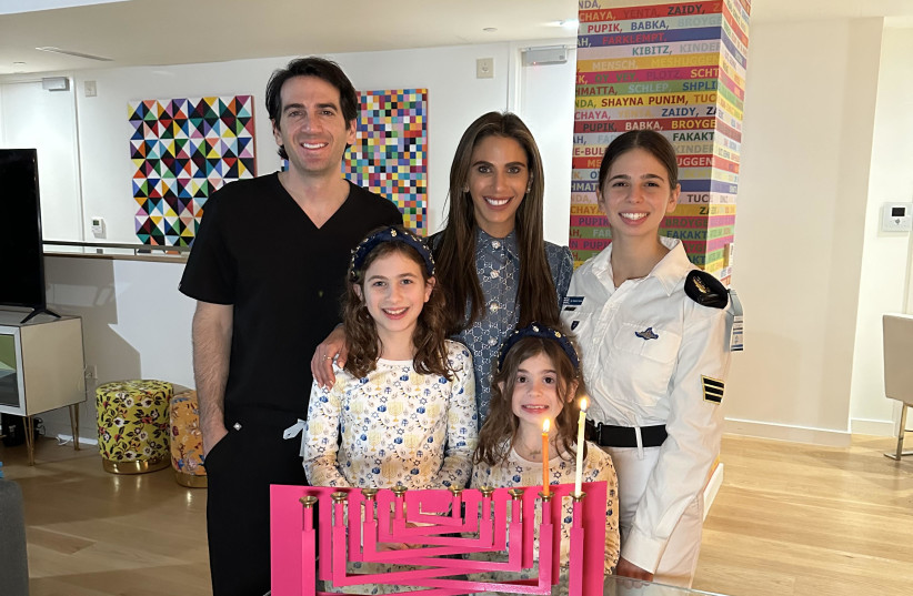  The Savetsky family hosts Sgt. Shachar on the first night of Hanukkah in their home in New York. (photo credit: Yoav Davis for Davis Media, courtesy of FIDF)
