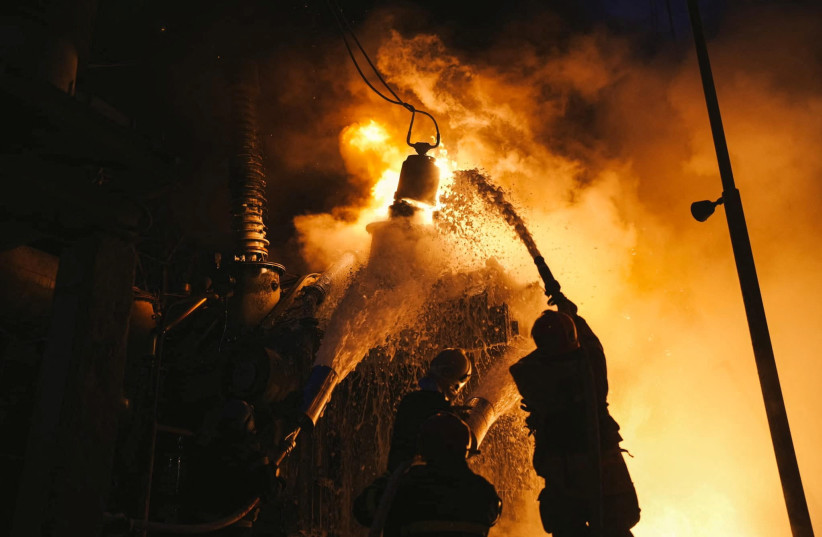 Firefighters work at a site of a critical power infrastructure object, which was hit during Russia's drones attacks in Kyiv, Ukraine, in this handout picture released December 19, 2022. (photo credit: Press service of the State Emergency Service of Ukraine/Handout via REUTERS)