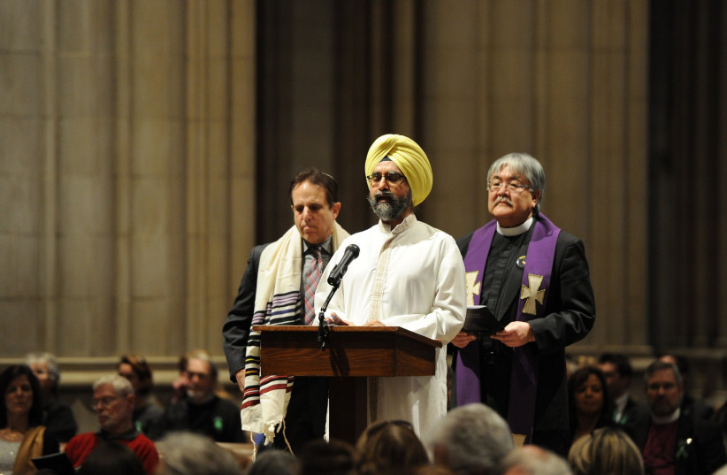 Dr. Rajwant Singh, founder of SCORE, speaks alongside Rabbi Steve Gutow, president of the JCPA, (left), and the Rev. Mel Kawakami, Sr. Minister of Newtown United Methodist Church in Newtown, Connecticut, right, during a National Vigil for Victims of Gun Violence on Dec. 12, 2013. (credit: Matt McClain-Pool/Getty Images/JTA)