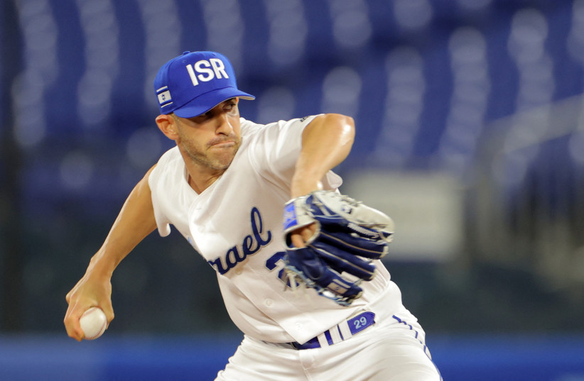  Alon Leichman, recently hired as a pitching coach for the Cincinnati Reds, pitches for Team Israel during the eighth inning of the Tokyo Olympic Games baseball opening round game against the United State in Yokohama, Japan, July 30, 2021.  (photo credit: Kazuhiro Fujihara/AFP via Getty Images)