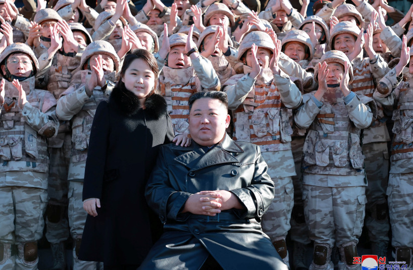  North Korean leader Kim Jong Un and his daughter attend a photo session with the scientists, engineers, military officials and others involved in the test-fire of the country's new Hwasong-17 intercontinental ballistic missile (ICBM) in this undated photo released on November 27, 2022. (photo credit: KCNA VIA REUTERS)