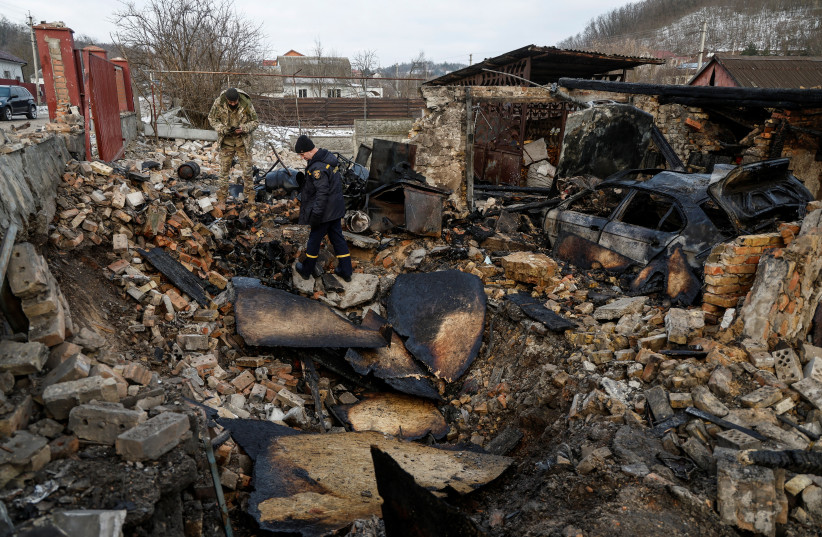  Investigators work a site of a residential building damaged during a Russian drone strike, amid Russia's attack on Ukraine, in the village of Stari Bezradychi, in Kyiv region, Ukraine December 19, 2022.  (credit: REUTERS/VALENTYN OGIRENKO)