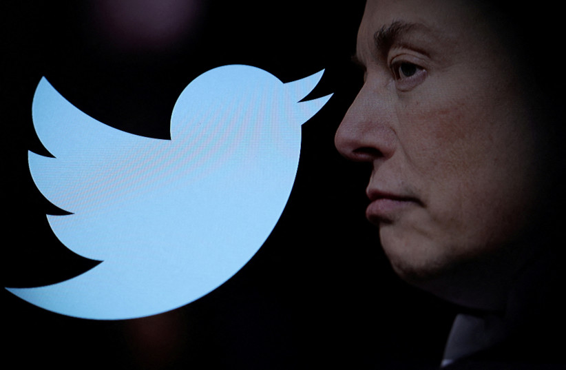   Twitter logo and a photo of Elon Musk are displayed through magnifier in this illustration taken October 27, 2022.  (credit: REUTERS/DADO RUVIC/ILLUSTRATION)