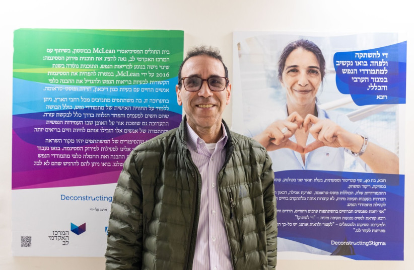 Stuart Katz stands in front of a display that is part of the Deconstructing Stigma campaign at Shaare Zedek Medical Center. (photo credit: MICHAEL ERENBURG)