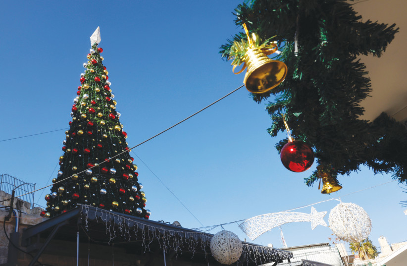  A CHRISTMAS tree provides festive cheer at the New Gate, Jerusalem’s Old City. (photo credit: MARC ISRAEL SELLEM)