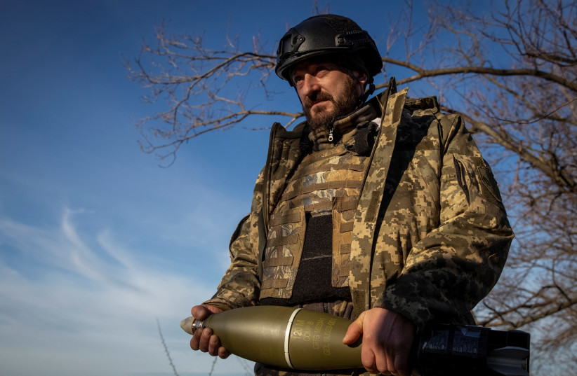  A Ukrainian serviceman is seen as he holds a mortar shell at a frontline, amid Russia's attack on Ukraine, in Donetsk Region, Ukraine, December 22, 2022. (credit: Oleksandr Ratushniak/Reuters)
