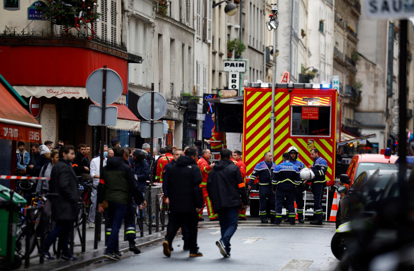  French police and firefighters secure a street after gunshots were fired killing two people and injuring several in a central district of Paris (photo credit: REUTERS)