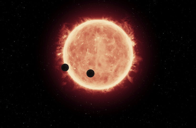  This artist's impression shows two Earth-sized worlds passing in front of their parent red dwarf star, which is much smaller and cooler than our Sun. The star and its orbiting planets TRAPPIST-1b and TRAPPIST-1c reside 40 light-years away. (credit: NASA, ESA, and G. Bacon (STScI)/Wikimedia Commons)