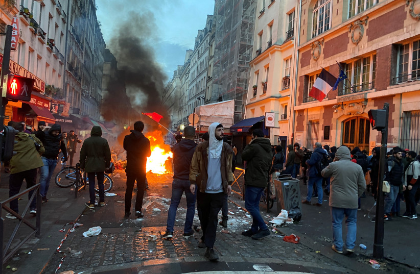  Protestors clash with French police during a demonstration near the Rue d'Enghien after gunshots were fired killing and injuring several people in a central district of Paris, France, December 23, 2022 (photo credit: CLOTAIRE ACHI / REUTERS)