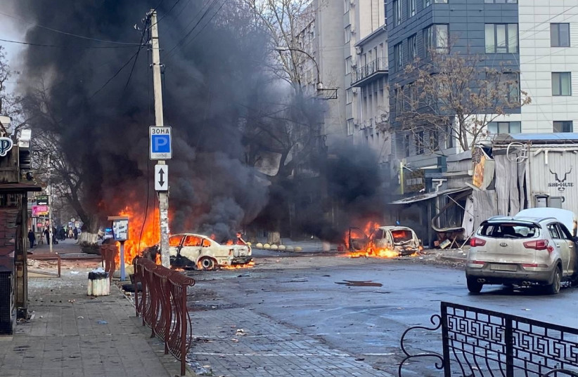 Cars burn on a street after a Russian military strike, amid Russia's attack of Ukraine, in Kherson, Ukraine, December 24, 2022. (photo credit: Ukrainian Presidential Press Service/Handout via REUTERS)