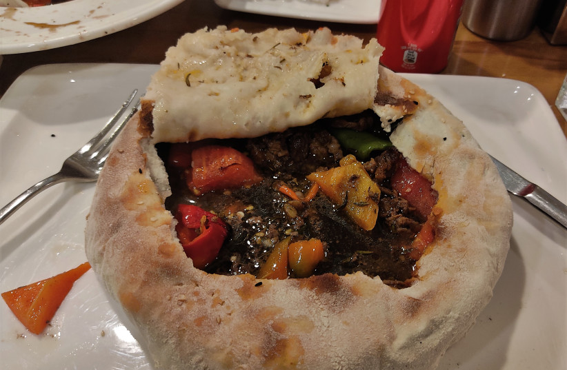  A lamb and vegetable stew, typical of the local cuisine baked in a bread casing. (credit: ORI LEWIS)