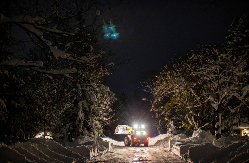  A snow plow works along Hillside Drive during a break in the snow storm hitting the Buffalo area in Orchard Park, New York, US November 19, 2022. (photo credit: REUTERS/CARLOS OSORIO)