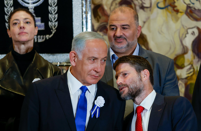  Likud leader MK Benjamin Netanyahu speaks with Religious Zionist party head MK Bezalel Smotrich at a swearing-in ceremony of the 25th Knesset, at the Israeli parliament in Jerusalem, November 15, 2022.  (photo credit: OLIVIER FITOUSSI/FLASH90)