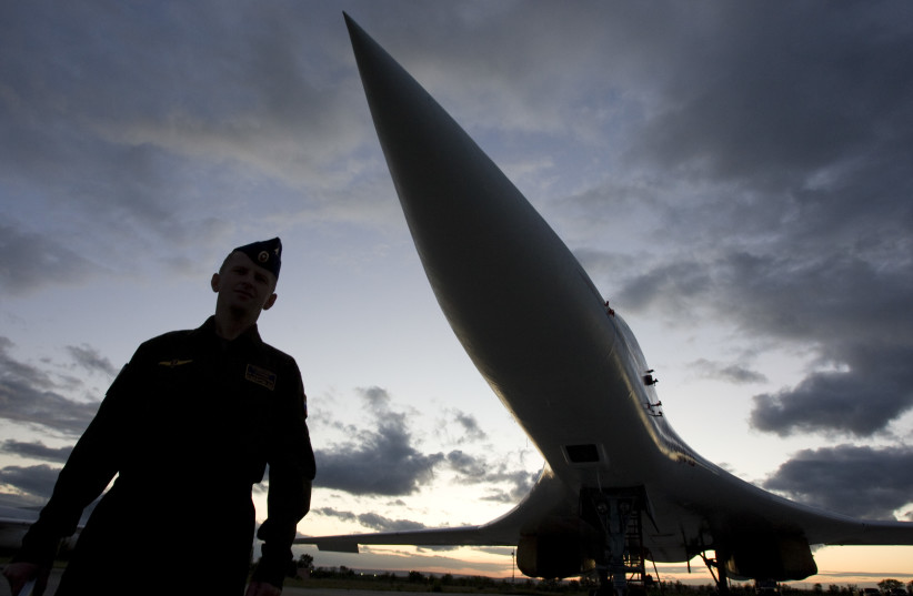A Russian officer stands in front of a TU-160 bomber, or Blackjack, at a military airbase in Engels, some 900 km (559 miles) south of Moscow, August 7, 2008. (photo credit: REUTERS/SERGEI KARPUKHIN)