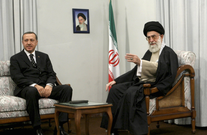 Iran's Supreme Leader Ayatollah Ali Khamenei (R) speaks with Turkish officials while meeting Turkey's Prime Minister Tayyip Erdogan in Tehran, December 3, 2006. (credit: REUTERS/ISNA)