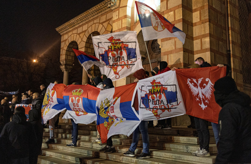  Demonstrators hold flags during a rally in support of ethnic Serbs who are protesting against Pristina government actions in northern Kosovo, in Belgrade, Serbia, December 12, 2022.  (photo credit: MARKO DJURICA/REUTERS)