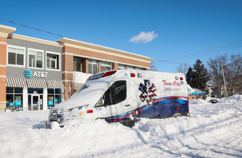  An ambulance is left stranded on the road following a winter storm that hit the Buffalo region on Main St. in Amherst, New York, US, December 25, 2022.  (photo credit: Sydney Gros-McDermid/Reuters)
