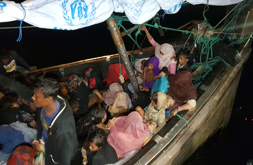  Rohingya refugees arrive by boat at a port in Lhokseumawe, Aceh, Indonesia, December 31, 2021.  (credit: REUTERS/Hidayatullah Tahjuddin)