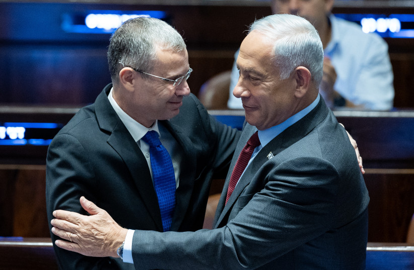  Likud Head MK Benjamin Netanyahu speaks with MK Yariv Levin during a vote for the new Knesset speaker at the assembly hall of the Knesset, the Israeli parliament in Jerusalem, on December 13, 2022. (photo credit: YONATAN SINDEL/FLASH90)