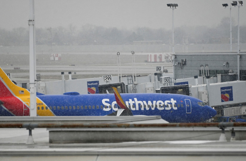  A plane sits on the airfield as flight cancellations mount during a cold weather front as a weather phenomenon known as a bomb cyclone hits the Upper Midwest, at Midway International Airport in Chicago, Illinois, U.S., December 22, 2022. (photo credit: MATT MARTON/REUTERS)
