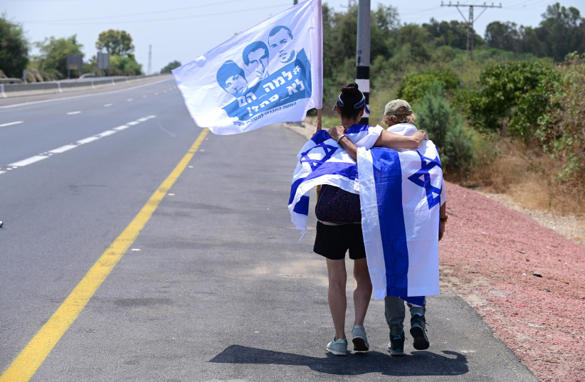  Friends, family and activists hold a protest march calling for the release of  of late Israeli soldiers Oron Shaul, Hadar Goldin and captive Israeli citizen Avera Mengistu near the Israeli Gaza Border, in southern Israel, August 5, 2022 (credit: TOMER NEUBERG/FLASH90)