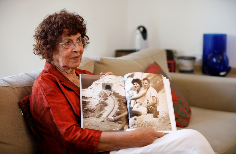 Nadia, widow of Israeli spy Eli Cohen, shows a photograph of herself with her late husband, during an interview with Reuters in Herzliya, Israel, October 6, 2019. (credit: REUTERS/AMIR COHEN)