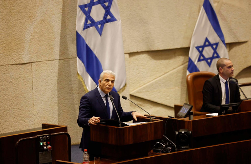 Former prime minister Yair Lapid speaking at the Knesset plenum as the new government takes their positions. (photo credit: MARC ISRAEL SELLEM)