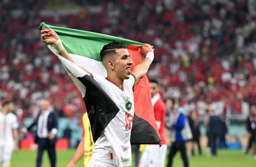  MOROCCO’S DEFENDER #18 Jawad El Yamiq waves the Palestinian flag after his team won the World Cup match against Canada, in Doha, Dec. 1.  (photo credit: NATALIA KOLESNIKOVA/AFP via Getty Images)