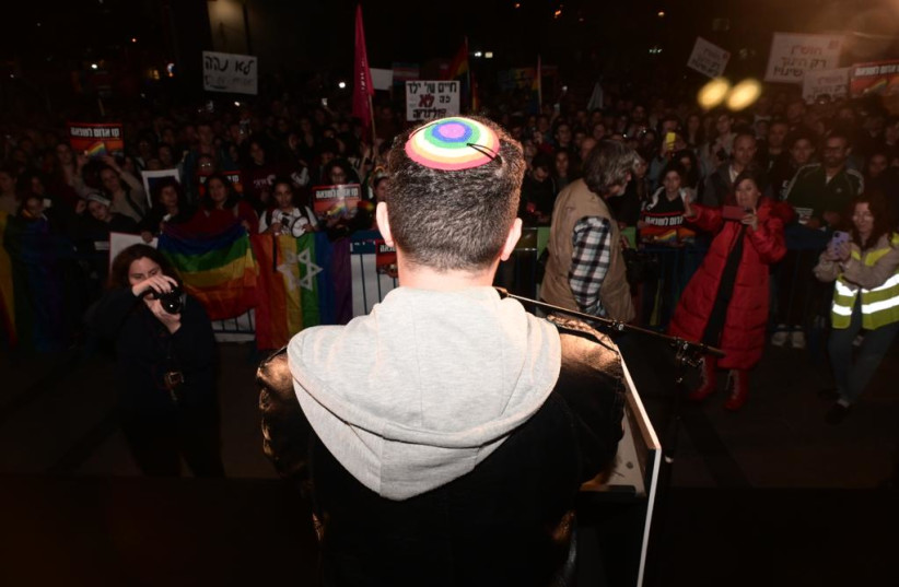  A man wearing a pride Kippah stands with other LGBTQ+ protesters demonstrating against the new Israeli government, December 29, 2022 (credit: AVSHALOM SASSONI/ MAARIV)