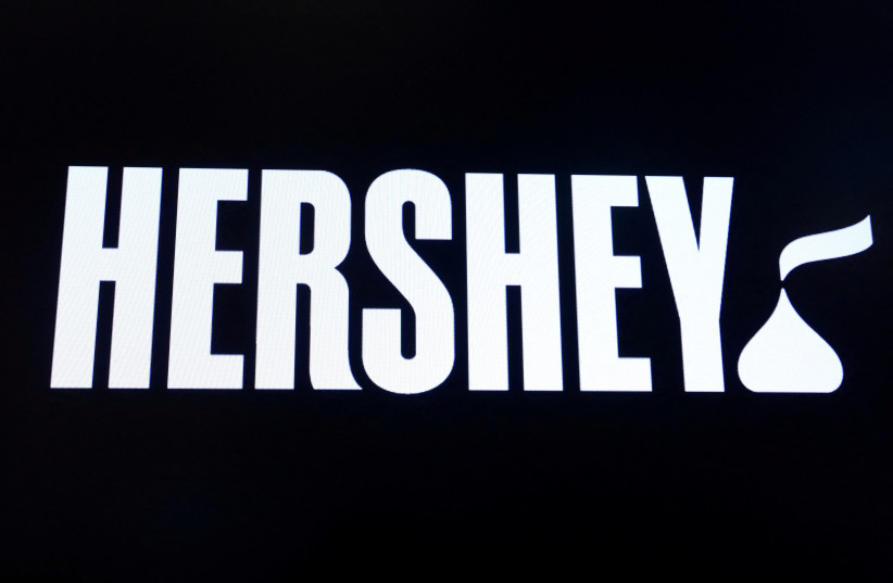   The company logo for Hershey Co. is displayed on a screen on the floor of the New York Stock Exchange (NYSE) in New York, U.S., March 4, 2019 (photo credit: BRENDAN MCDERMID/REUTERS)
