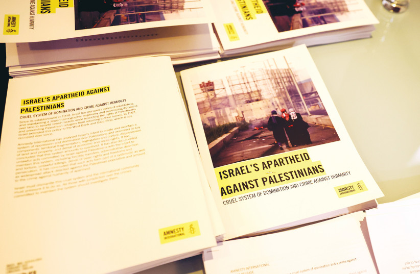  COPIES OF Amnesty International’s report named ‘Israel’s Apartheid Against Palestinians’ are put on display at a news conference in Jerusalem last year. (photo credit: RONEN ZVULUN / REUTERS)