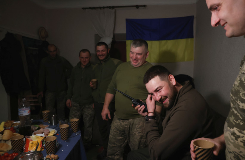  Ukrainian soldier and Mortar Battery Commander Taras Lukinchuk, 30, speaks to soldiers in the field on his radio to wish them a Happy New Year on New Year's Eve, in a military rest house, as Russia's attack on Ukraine continues, in region of Donetsk, Ukraine, January 1, 2023. (credit: REUTERS/CLODAGH KILCOYNE)