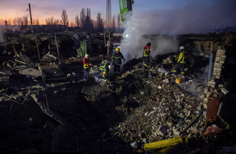  Rescuers work at an area heavily damaged by a Russian missile strike, amid Russia's attack on Ukraine, in Mykolaiv, Ukraine December 31, 2022.  (photo credit: REUTERS/OLEKSANDR RATUSHNIAK)