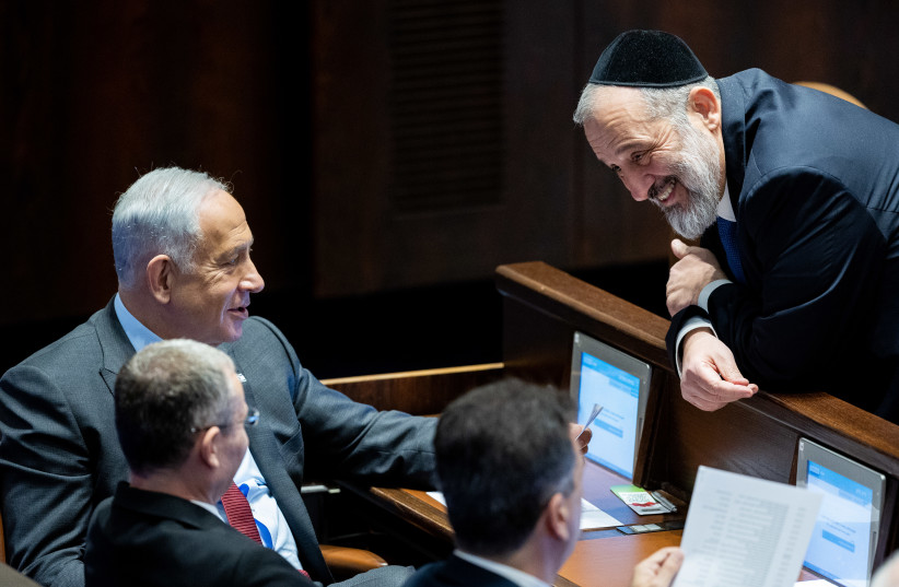  Likud Head MK Benjamin Netanyahu speaks with MK Aryeh Deri during a vote for the new Knesset speaker at the assembly hall of the Knesset, the Israeli parliament in Jerusalem, on December 13, 2022.  (photo credit: YONATAN SINDEL/FLASH90)