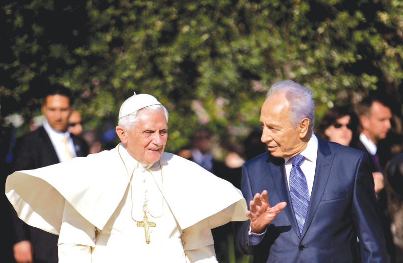  POPE BENEDICT XVI and then-president Shimon Peres walk in the garden of the President’s Residence in Jerusalem, in 2009. (photo credit: Oded Balilty/Reuters)