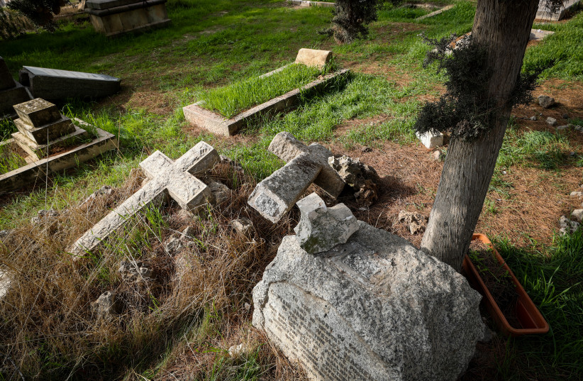 View of graves that were allegedly vandalized by jewish men, in the Christian cemetery on Mount Zion, in Jerusalem's Old City, January 4, 2023. (credit: JAMAL AWAD/FLASH90)