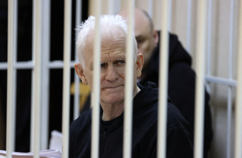  Nobel Peace Prize laureate Ales Byalyatski, who co-founded the Viasna human rights group, sits inside a defendants' cage during a court hearing in Minsk, Belarus January 5, 2023. (photo credit: VITALY PIVOVARCHIK/BELTA/HANDOUT VIA REUTERS)