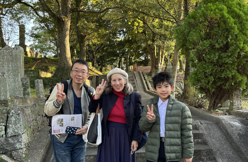  THE WRITER (center) was helped in her search for the Jewish graveyard by two Nagasaki locals – nine-year-old Kotaro Takeda, who with his father, Takashi, were visiting the Jewish cemetery for a school project.  (credit: LIANE GRUNBERG WAKABAYASHI)