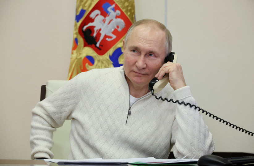  Russian President Vladimir Putin speaks on the phone with David Shmelev from Stavropol Region, a 7-year-old participant of a New Year's and Christmas charity event, at the Novo-Ogaryovo state residence outside Moscow, Russia January 5, 2023. (credit: SPUTNIK/MIKHAIL KLIMENTYEV/ VIA REUTERS)