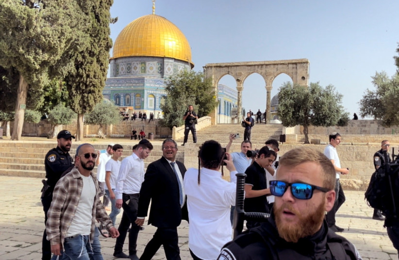  Israeli far right lawmaker Itamar Ben Gvir walks together with other Jews during a visit to the compound known to Muslims as Noble Sanctuary and to Jews as Temple Mount in Jerusalem's Old City May 29, 2022 (photo credit: REUTERS/SINAN ABU MAYZER)