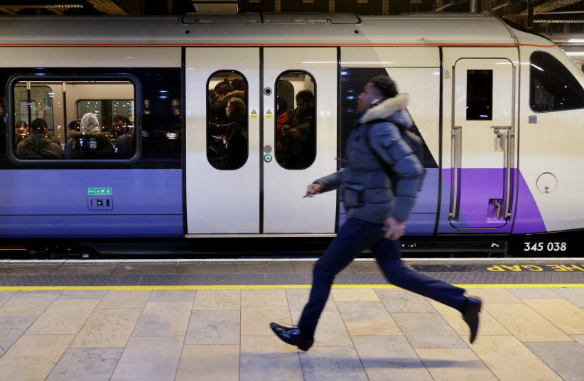  A passenger runs to catch one of the final westbound Elizabeth Line trains at Paddington Station, as British rail workers kicked off the new year with a week-long strike, in London, UK, January 3, 2023 (photo credit: REUTERS/KEVIN COOMBS)