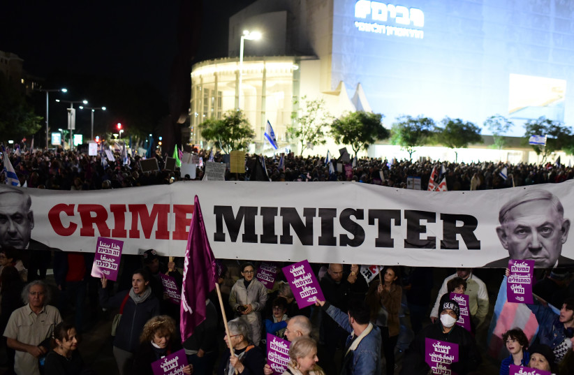  Thousands of protestors gather in Tel Aviv to protest against the new Israeli government and Justice Minister Yariv Levin's plans for judicial reform. A large ''Crime Minister'' banner with Benjamin Netanyahu's face can be seen in the background, January 7, 2023 (credit: TOMER NEUBERG)